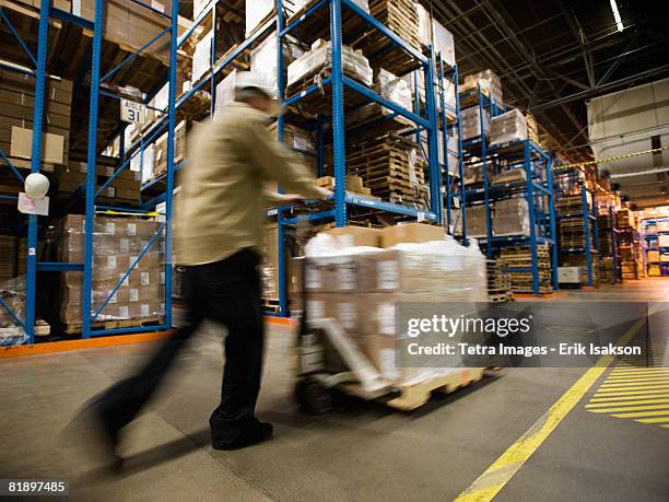 warehouse worker pushing palette - helmet cart stock pictures, royalty-free photos & images