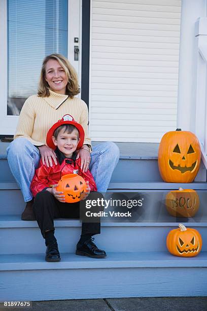 mother and son dressed in fireman halloween costume - boy fireman costume stock pictures, royalty-free photos & images