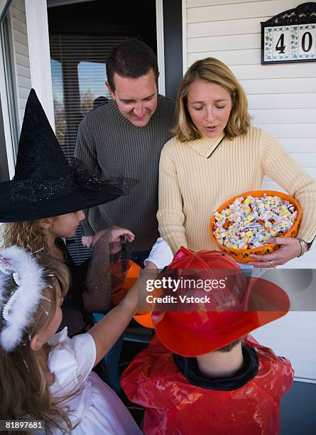 children in halloween costumes trick or treating - boy fireman costume stock pictures, royalty-free photos & images