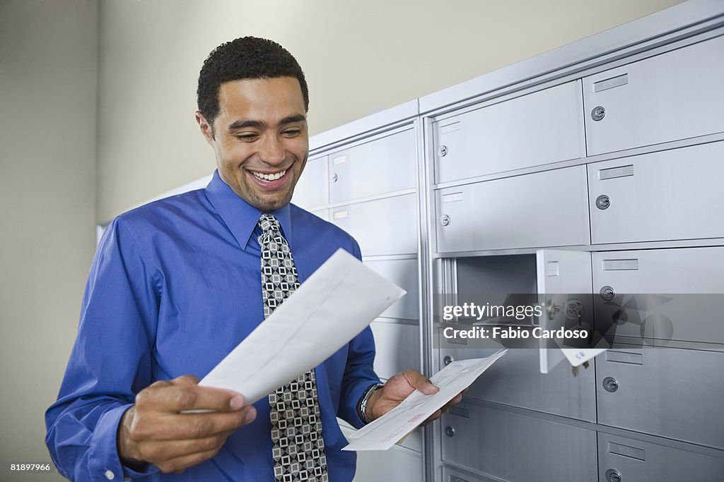 African businessman reading mail