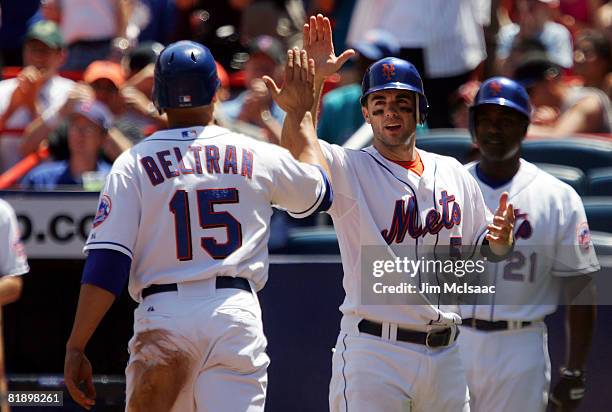David Wright and Carlos Beltran of the New York Mets celebrate after scoring in the third inning against the San Francisco Giants on July 10, 2008 at...