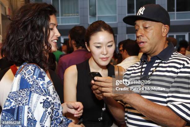 Eunni Cho, Russell Simmons and Jaslene Gonzalez attend SHEPARD FAIREY "May Day" Exhibition Opening Reception at Deitch Projects on May 1, 2010 in New...