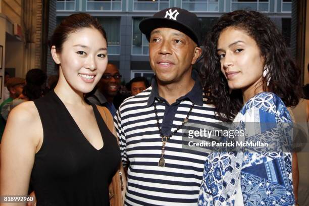 Eunni Cho, Russell Simmons and Jaslene Gonzalez attend SHEPARD FAIREY "May Day" Exhibition Opening Reception at Deitch Projects on May 1, 2010 in New...