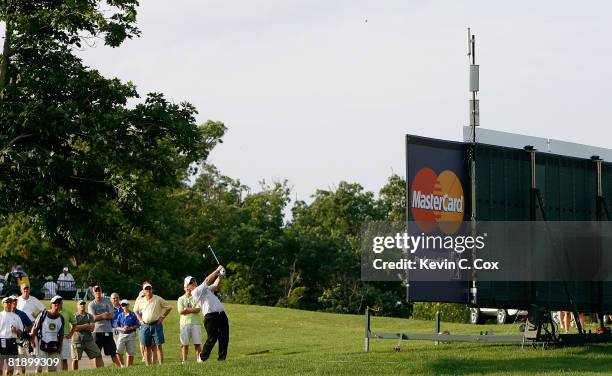 David Duval plays his second shot around an electronic scoreboard on the 15th hole during the first round of the 2008 John Deere Classic at TPC at...