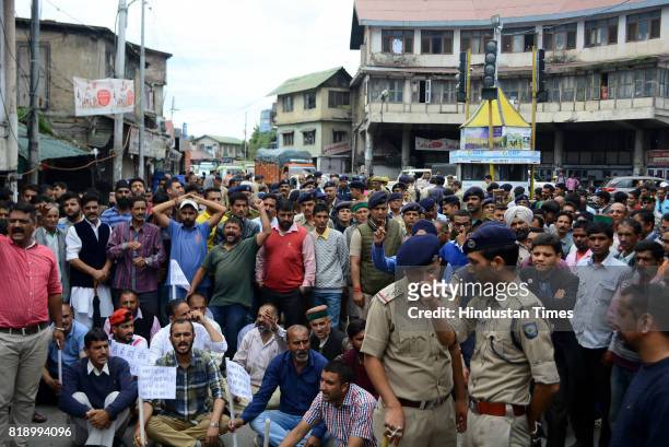 Local people stage chakkajam at Dhalli after the death of an accused of rape and murder of teenage girl in police custody on July 19, 2017 in Shimla,...