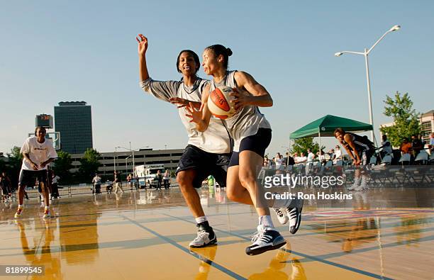 Allison Feaster of the Indiana Fever drives on Tammy Sutton-Brown of the Fever as they practice outside near Conseco Fieldhouse July 10, 2008 in...