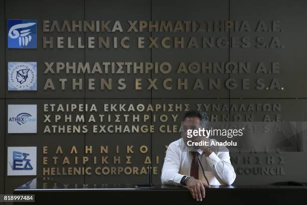 Man speaks on the phone at a bank in Athens, Greece on July 18, 2017. Greek government prepares to become indebted to free markets three years after...