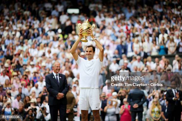 Roger Federer of Switzerland celebrates victory with the trophy after the Gentlemen's Singles final of the Wimbledon Lawn Tennis Championships at the...