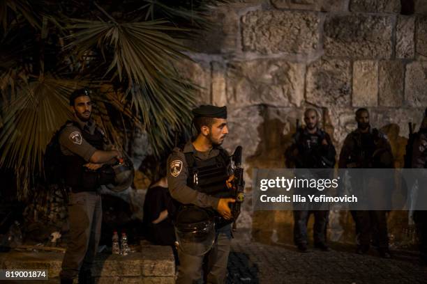 Approximately 4,000 Palestinian Muslims pray outside the entrance to the old city of Jerusalem as it is partially blocked by Israeli Police on July...