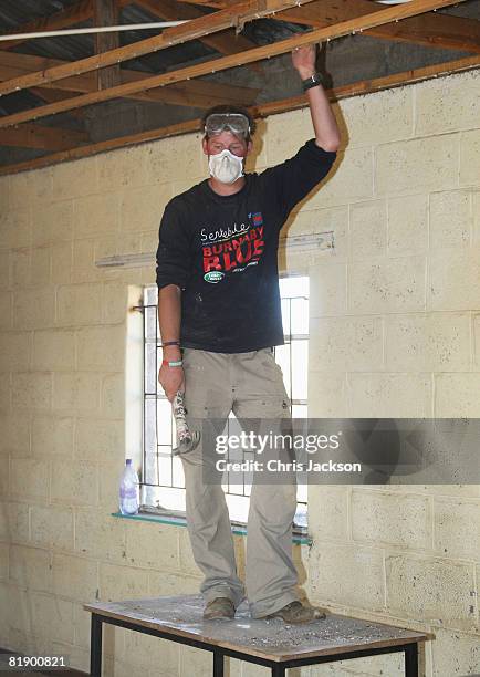 Prince Harry helps rebuild a school on July 8, 2008 in Buthe Buthe, Lesotho. Prince Harry and 26 soldiers from the Household Cavalry are in Lesotho...