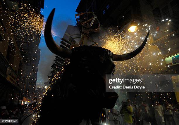 Fireworks bull effigy or 'Toro del Fuego' is run through the streets of Pamplona during the San Fermin running of the bulls fiesta on July 10, 2008...