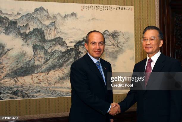Mexican President Felipe Calderon shakes hands with Chinese Premier Wen Jiabao during a meeting at the Zhongnanhai compound on July 11, 2008 in...