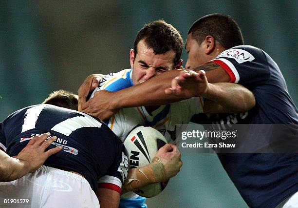 Anthony Laffranchi of the Titans is tackled during the round 18 NRL match between the Sydney Roosters and the Gold Coast Titans at the Sydney...