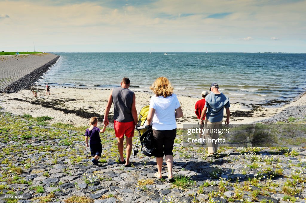 Family with children going to the beach, Zeeland,the Netherlands