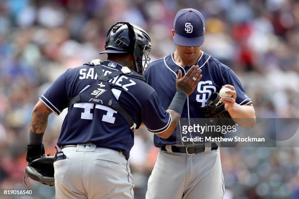 Starting pitcher Clayton Richard and catcher Hector Sanchez of the San Diego Padres confer in the fourth inning against the Colorado Rockies at Coors...