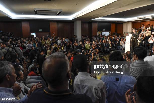 Members of the media listen as Lawmaker Henry Ramos Allup speaks during a press conference held by the opposition coalition announcing the goals of a...