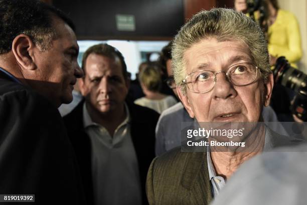Lawmaker Henry Ramos Allup, right, leaves following a press conference held by the opposition coalition announcing the goals of a transitional...