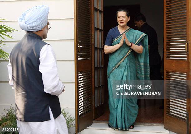 Chairperson of United Progressive Alliance and Congress Party President Sonia Gandhi welcomes Indian Prime Minister Manmohan Singh prior to a...
