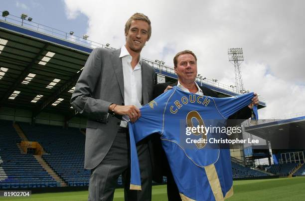 Peter Crouch with manager Harry Redknapp pose with Crouch's new Portsmouth shirt during the press conference to announce the signing of Peter Crouch...