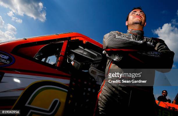 Chris Windom, driver of the Baldwin Brothers/Fox Paving/Central Abrasives Chevrolet, stands next ot his truck during qualifying for the NASCAR...