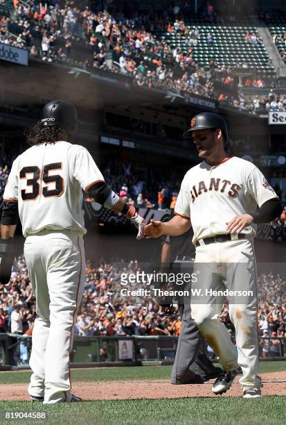 Brandon Crawford and Conor Gillaspie of the San Francisco Giants celebrate after they both scored on a pitch-hit two-run rbi double from Buster Posey...