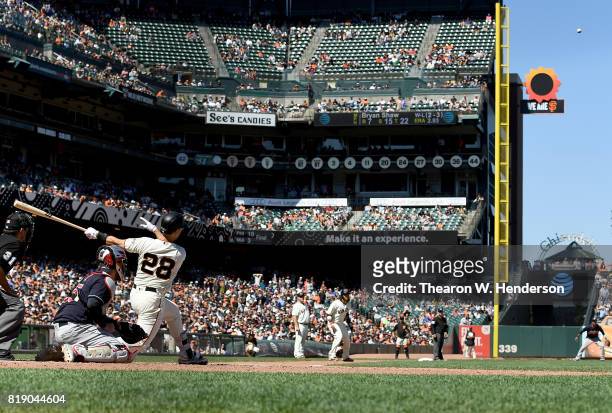 Buster Posey of the San Francisco Giants hits a pitch-hit two-run rbi double against the Cleveland Indians in the bottom of the eighth inning at AT&T...