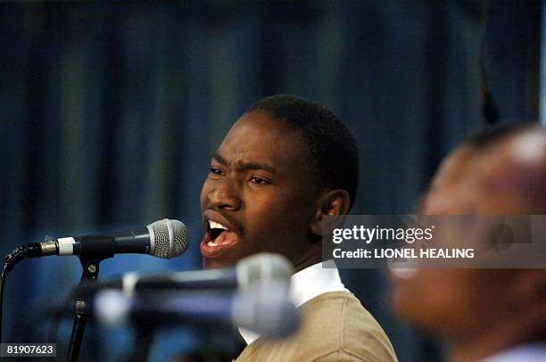 Member of a gospel choir sings at a church service at the Oasis of Life Family Church on July 6, 2008 in Daveyton, Johannesburg. As the church crowd...