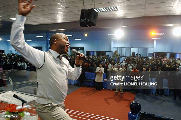 Gospel singer performs on a stage at a church service at the Oasis of Life Family Church on July 6, 2008 in Daveyton, Johannesburg. As the church...