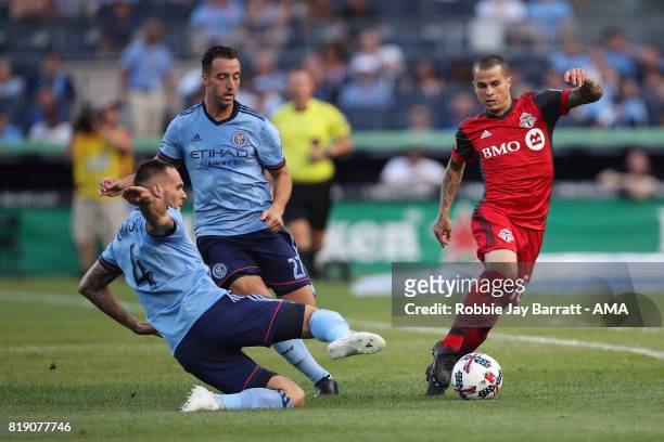 Maxime Chanot of New York City and Sebastian Giovinco of Toronto FC during MLS fixture between Toronto FC and New York City FC at Yankee Stadium on...