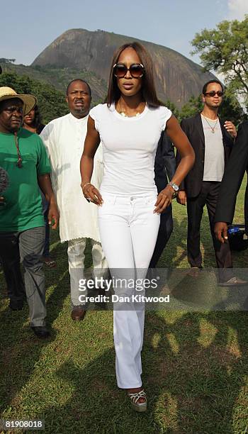 Super model Naomi Campbell prepares to plant a Cocoa Tree in Abuja Central Park and Botanical Gardens on July 11, 2008 in Abuja, Nigeria. The...