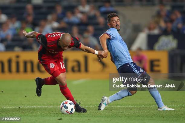 Jason Hernandez of Toronto FC and David Villa of New York City during MLS fixture between Toronto FC and New York City FC at Yankee Stadium on July...