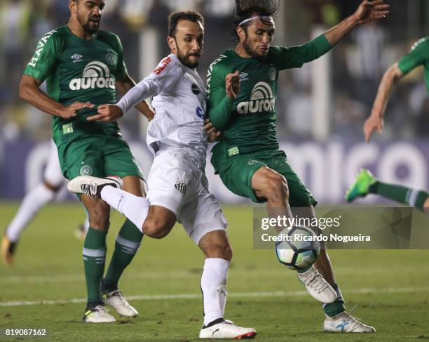 Thiago Ribeiro of Santos battles for the ball with Apodi of Chapecoense during the match between Santos and Chapecoense as a part of Campeonato...