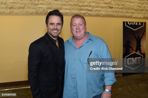 Singer-songwriter Charles Esten and Mike Sistad of ASCAP take photos backstage before Charles Esten's #OneSingleYear Celebration Concert at CMA...