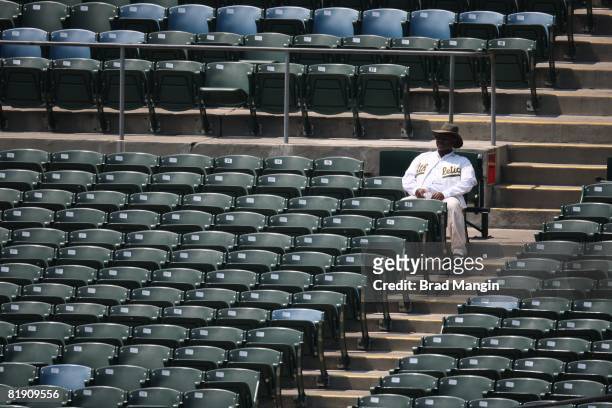 An Oakland Athletics fan is surrounded by empty seats during the game between the Seattle Mariners and the Oakland Athletics at the McAfee Coliseum...