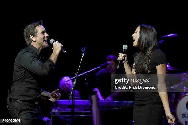 Charles Esten and Karla Davis perform on stage for Charles Esten's #OneSingleYear Celebration Concert at CMA Theater at the Country Music Hall of...