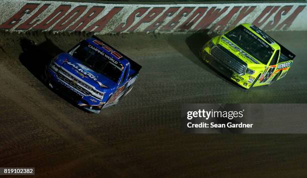 Stewart Friesen, driver of the Halmar International Chevrolet, leads Matt Crafton, driver of the Ideal Door/Menards Toyota, during the NASCAR Camping...