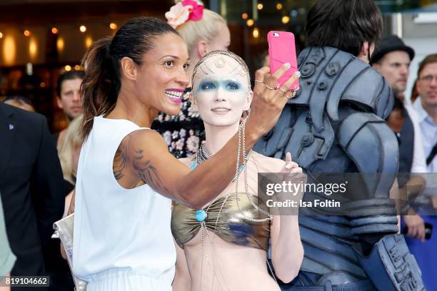 German presenter Annabelle Mandeng with a film figure during the 'Valerian - Die Stadt der Tausend Planeten' premiere at CineStar on July 19, 2017 in...