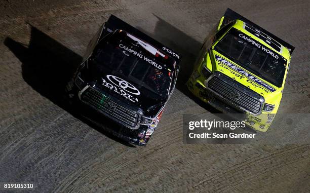 Christopher Bell, driver of the Toyota, races Matt Crafton, driver of the Ideal Door/Menards Toyota, during the NASCAR Camping World Truck Series 5th...