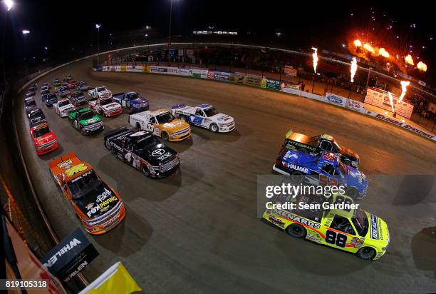 The field does a 4 wide parade lap before the start of the NASCAR Camping World Truck Series 5th Annual Dirt Derby 150 at Eldora Speedway on July 19,...