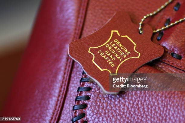 Leather label hangs from a bag on display at the Shakra Leather Arts store in the Dharavi area of Mumbai, India, on Tuesday, July 18, 2017. India's...