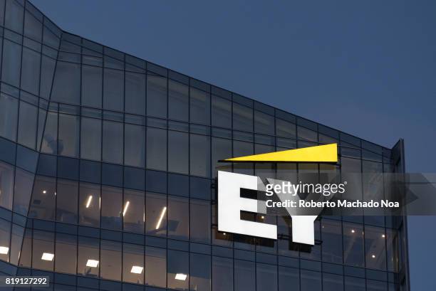 Logo or sign in modern downtown skyscraper. EY is a global leader in assurance, tax, transaction and advisory services.