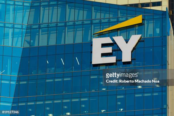 Logo or sign in modern downtown skyscraper. EY is a global leader in assurance, tax, transaction and advisory services.