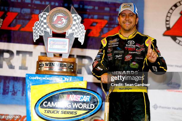 Matt Crafton, driver of the Ideal Door/Menards Toyota, celebrates after winning the NASCAR Camping World Truck Series 5th Annual Dirt Derby 150 at...