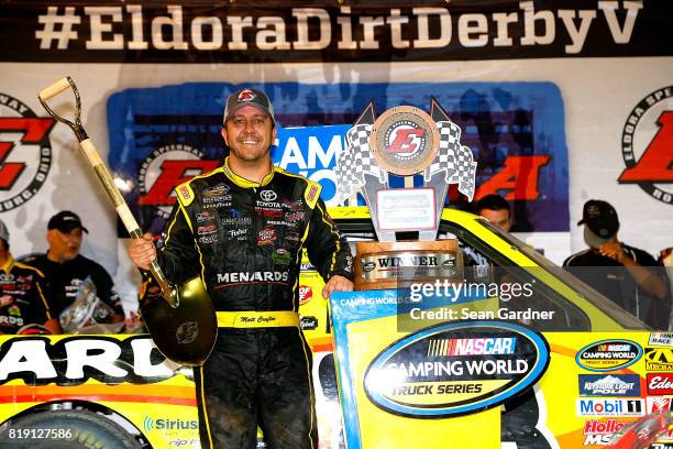 Matt Crafton, driver of the Ideal Door/Menards Toyota, celebrates after winning the NASCAR Camping World Truck Series 5th Annual Dirt Derby 150 at...