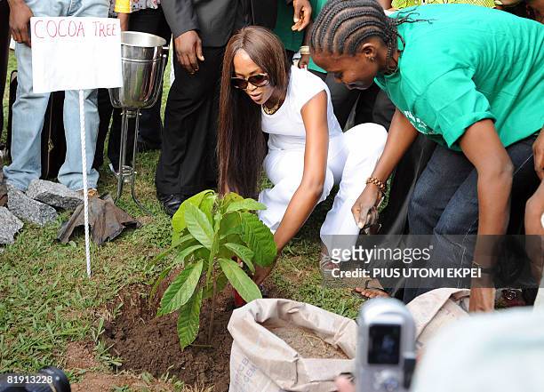British supermodel Naomi Campbell tries to plant a cocoa tree on July 11, 2008 during the official launch of the one million trees event at the...