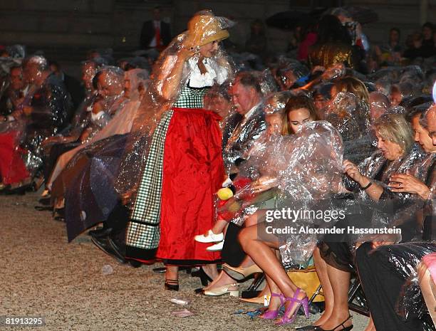 Maya Flick attends with rain coat the opera 'Carmen' at the Thurn und Taxis castle festival on July 11 in Regensburg, Germany.