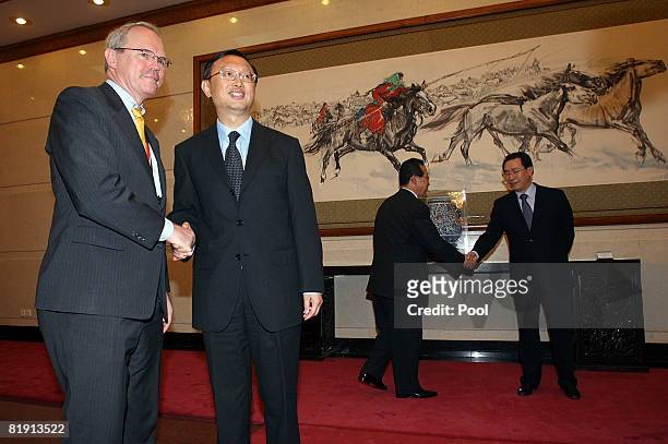 Chinese Foreign minister Yang Jiechi shaking hands with U.S. Assistant Secretary of State Christopher Hill as Chinese Vice Foreign Minister Wu Dawei...