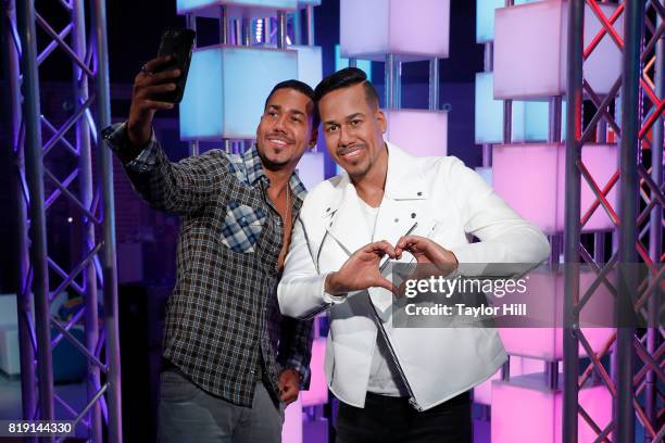 Musician Romeo Santos takes a selfie with his wax figure at its unveiling at Madame Tussaud's Wax Museum on July 19, 2017 in Times Square in New York...