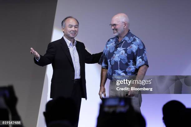 Billionaire Masayoshi Son, chairman and chief executive officer of SoftBank Group Corp., left, introduces Marc Raibert, founder and chief executive...