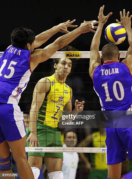 France's Tula and Tolar jump to block Brazil's Giga's spike during their Volleyball World League fifth round match in Belo Horizonte, Brazil on July...